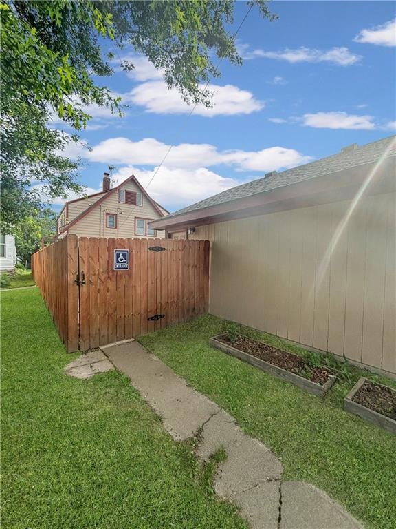 view of yard featuring a garden, a gate, and fence