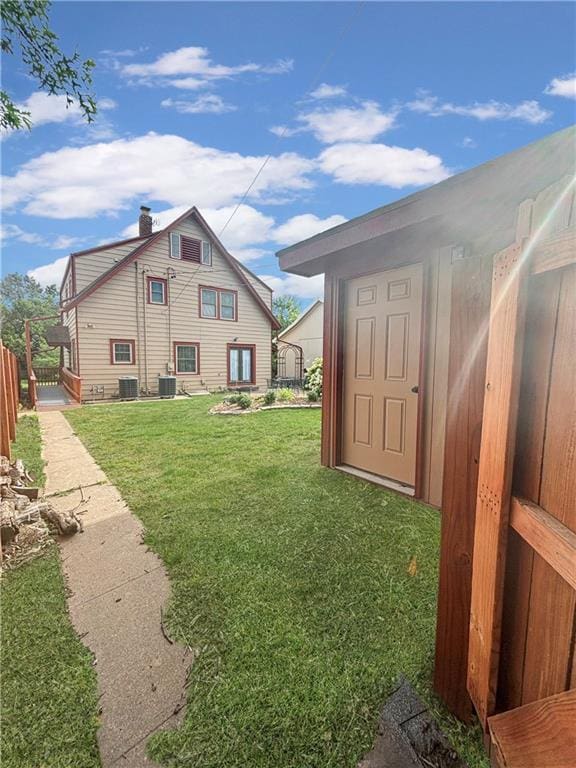 exterior space featuring central AC and fence