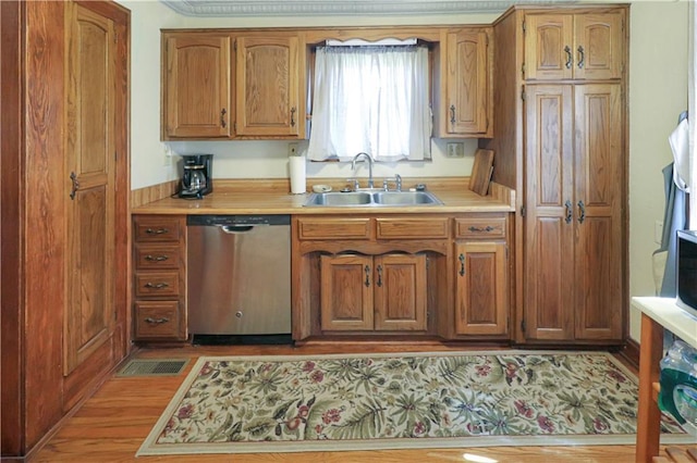 kitchen with a sink, visible vents, light countertops, brown cabinets, and dishwasher