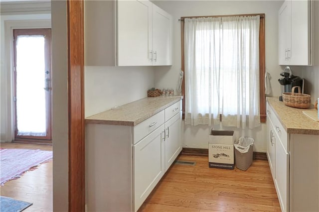 kitchen featuring light hardwood / wood-style flooring and white cabinets