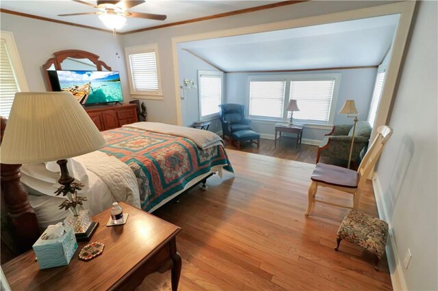 bedroom featuring wood-type flooring, ornamental molding, and ceiling fan