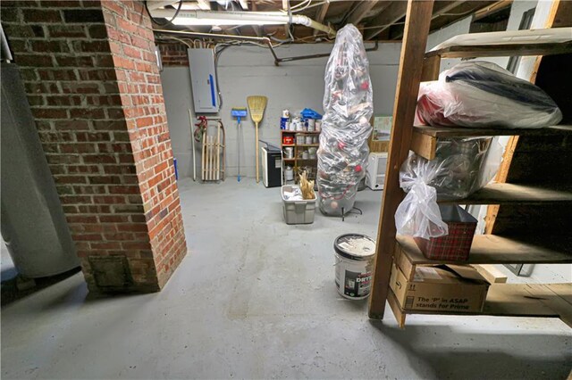 basement with electric panel and brick wall