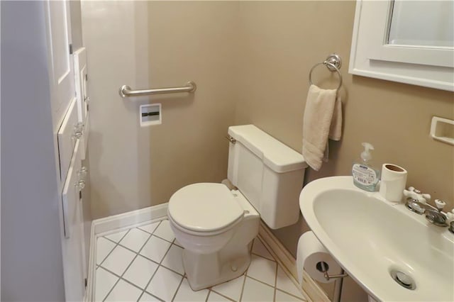 bathroom with tile patterned flooring, toilet, and sink