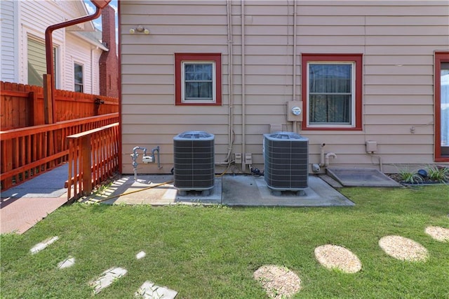 exterior details featuring cooling unit, electric meter, and fence