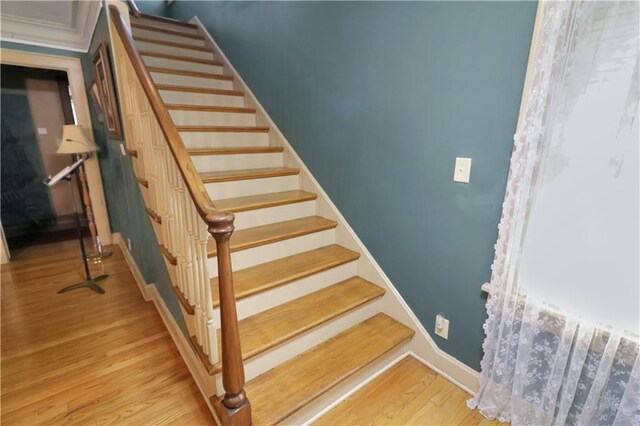 stairs featuring light wood-type flooring