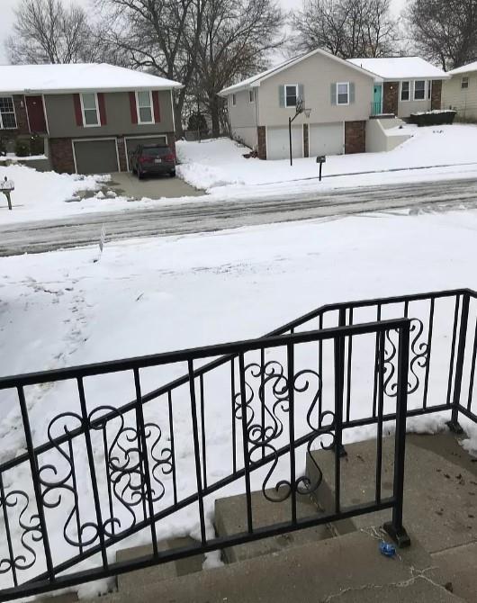 yard covered in snow with a garage