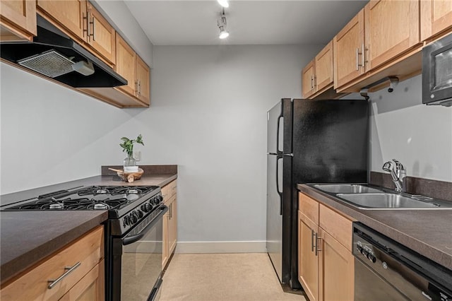 kitchen with black appliances, sink, and track lighting