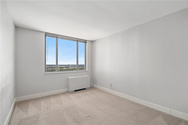 carpeted spare room with radiator heating unit