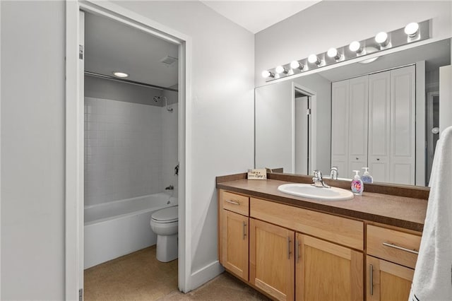 full bathroom featuring tiled shower / bath, vanity, and toilet