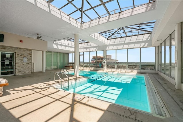 view of pool featuring a patio and glass enclosure