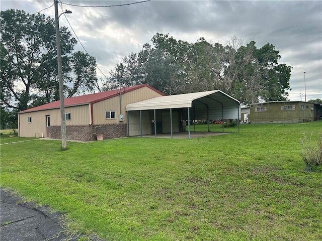 back of house featuring a carport and a lawn