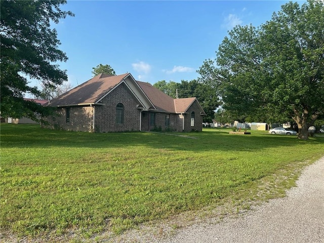 view of side of home featuring a lawn