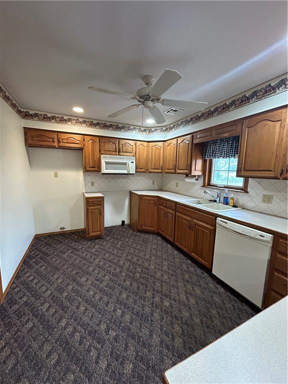 kitchen featuring sink, white appliances, and ceiling fan