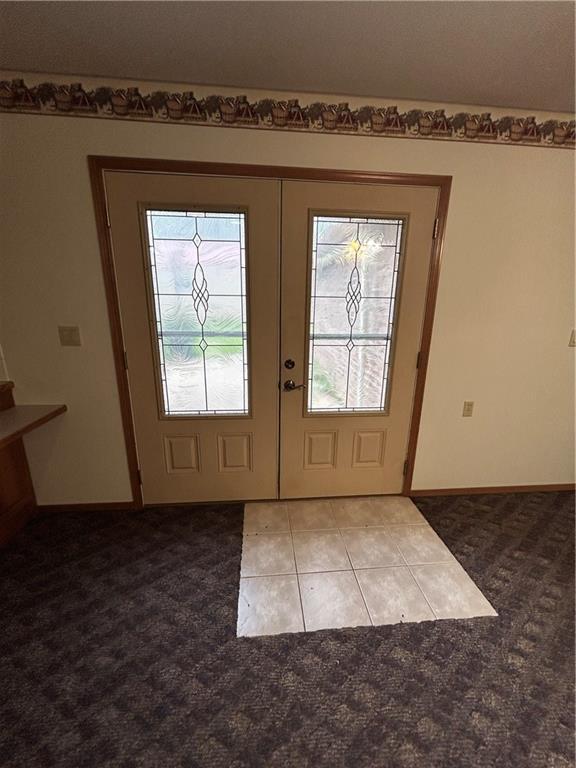 doorway to outside with tile patterned flooring and french doors