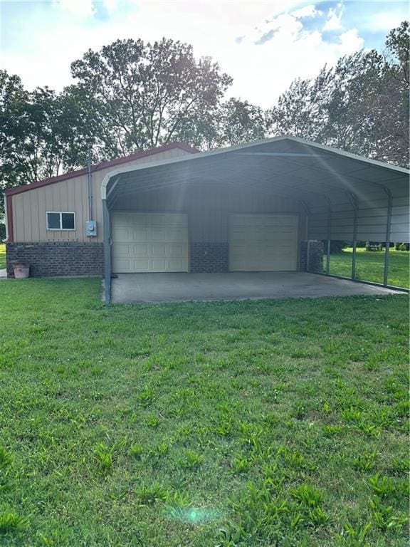 view of outbuilding with a lawn and a carport