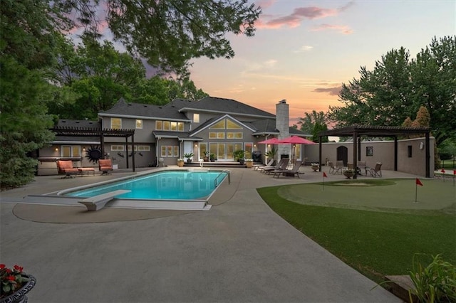 pool at dusk featuring a pergola, a patio area, and a diving board