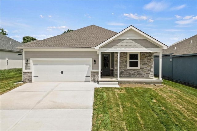 craftsman-style home featuring covered porch, a front yard, and a garage