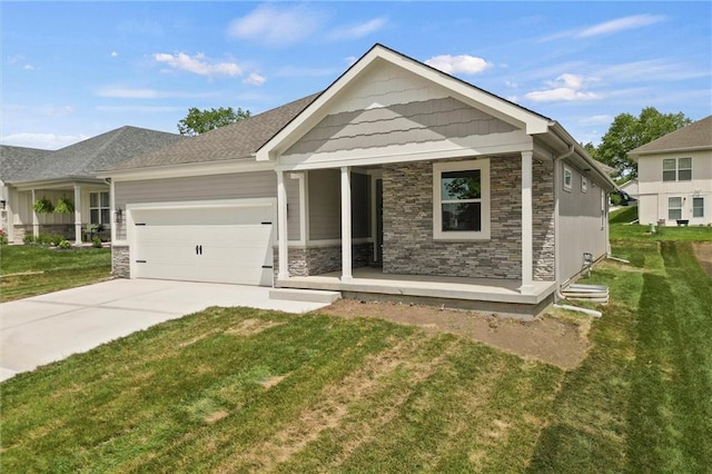 view of front of home featuring a porch, a garage, and a front yard