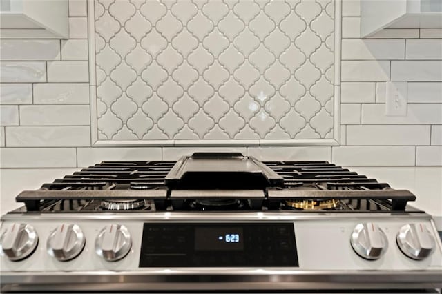 interior details with backsplash and stainless steel range oven