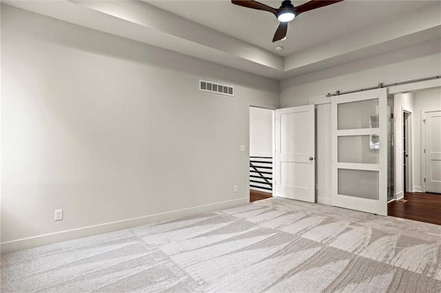 unfurnished bedroom with ceiling fan and light carpet