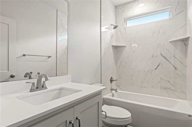 full bathroom with vanity, toilet, and tiled shower / bath