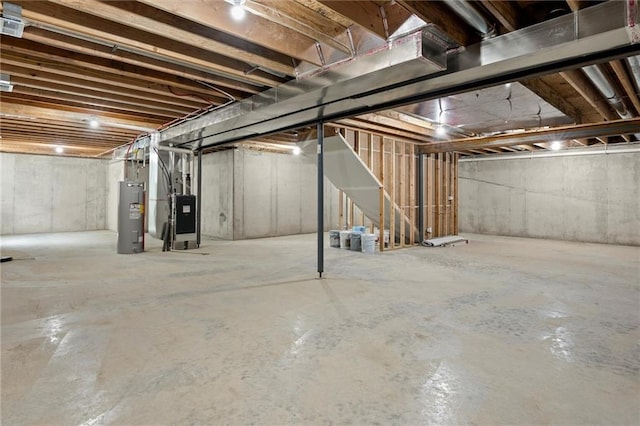 basement featuring heating unit and electric water heater