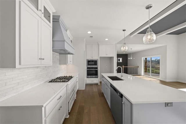 kitchen with stainless steel appliances, white cabinetry, and sink