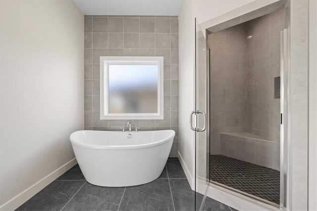 bathroom featuring plus walk in shower, tile patterned floors, and tile walls