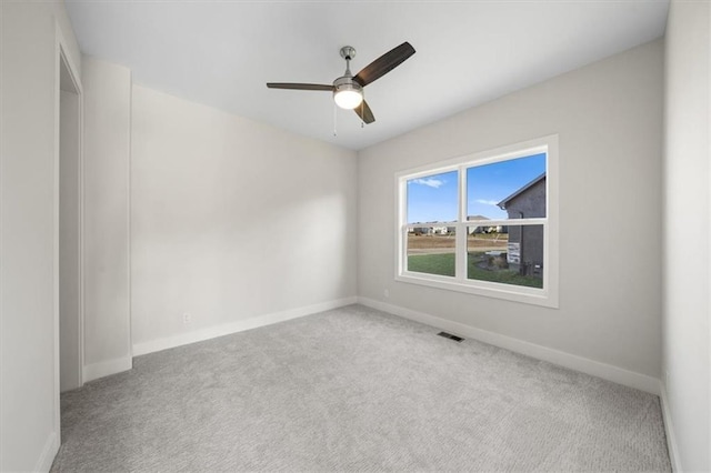 spare room featuring carpet and ceiling fan