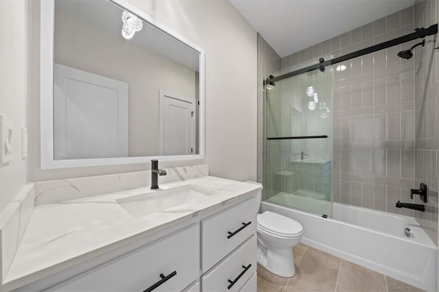 full bathroom featuring tile patterned flooring, vanity, toilet, and shower / bath combination with glass door