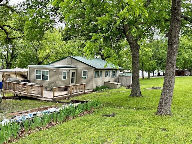 back of house featuring a yard and a wooden deck