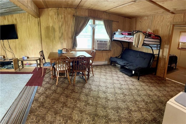 bedroom with wood walls, baseboard heating, and cooling unit