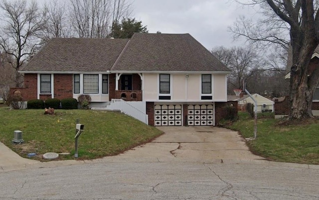 view of front of property featuring a garage and a front lawn