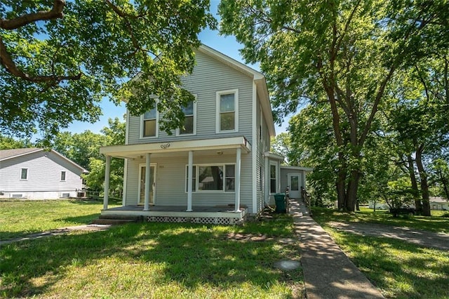 view of front of home featuring covered porch and a front yard