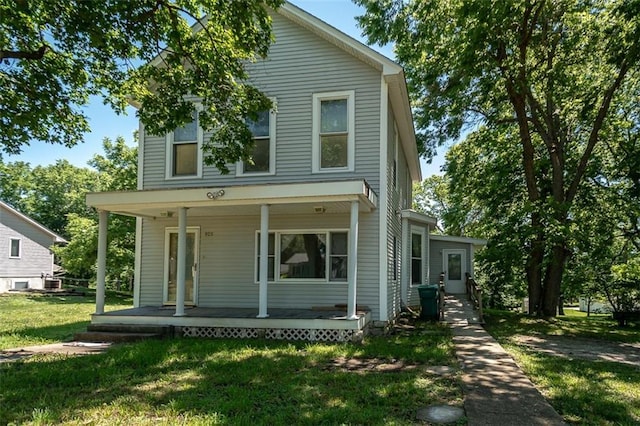 view of front of home featuring covered porch and a front lawn