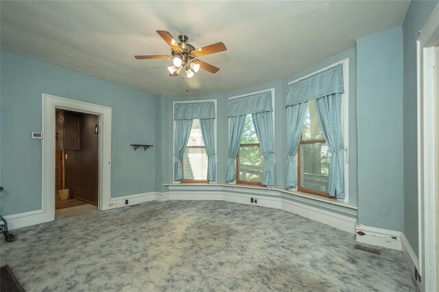 spare room featuring ceiling fan and carpet floors