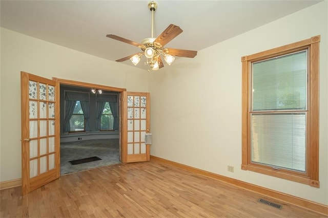 unfurnished living room featuring french doors, light hardwood / wood-style flooring, and ceiling fan