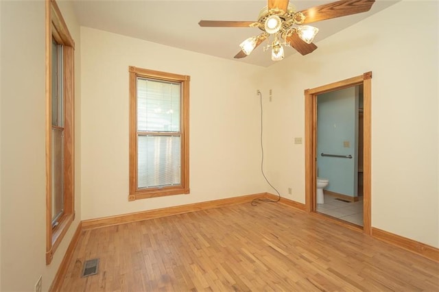 empty room with ceiling fan and light hardwood / wood-style floors