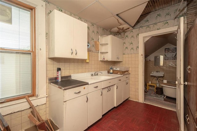 kitchen featuring white cabinets and dark parquet floors