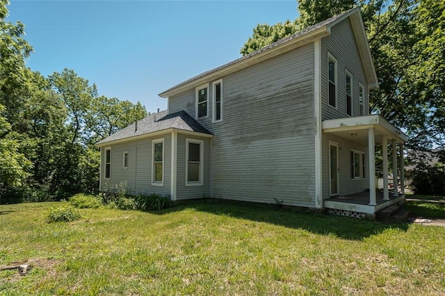 view of property exterior with a porch and a yard