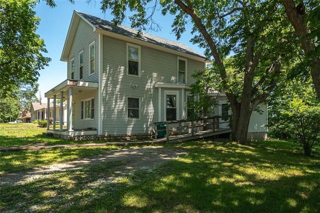 back of property featuring a yard