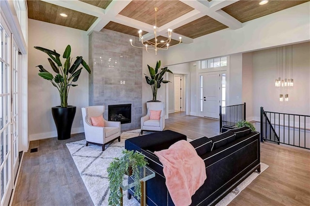 living room featuring coffered ceiling and wooden ceiling