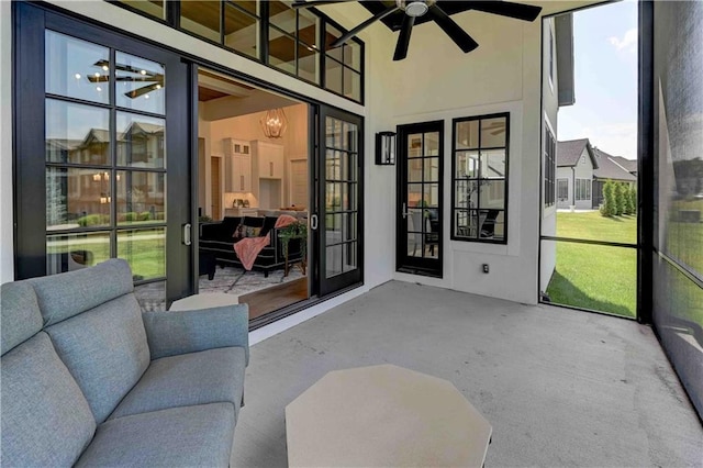 sunroom with ceiling fan with notable chandelier