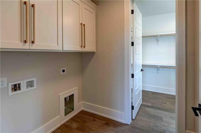 clothes washing area featuring electric dryer hookup, dark wood-type flooring, washer hookup, and cabinets