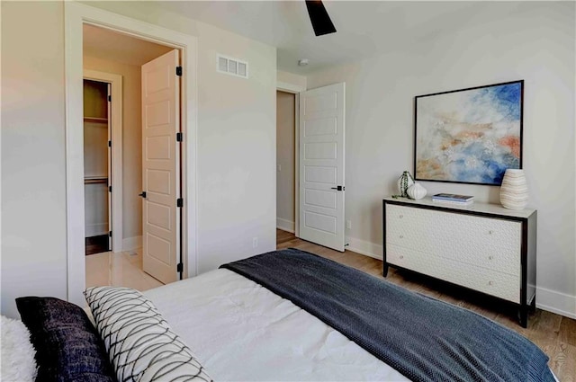 bedroom with a closet, ceiling fan, and hardwood / wood-style floors