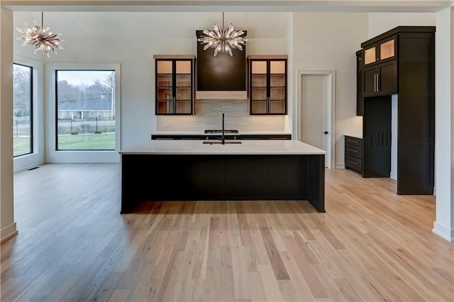 kitchen featuring a notable chandelier, hanging light fixtures, and light hardwood / wood-style flooring