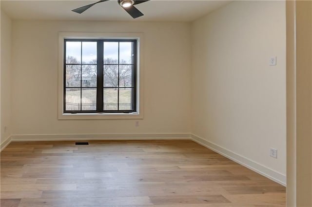 unfurnished room featuring ceiling fan and light wood-type flooring