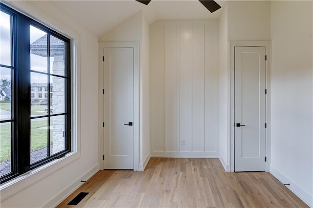 interior space with plenty of natural light, vaulted ceiling, and light hardwood / wood-style flooring