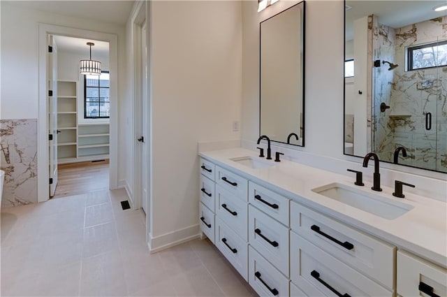 bathroom with tile patterned floors, vanity, and an enclosed shower