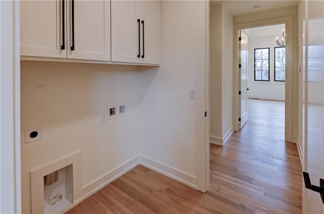 laundry area featuring cabinets, hookup for an electric dryer, light hardwood / wood-style flooring, hookup for a washing machine, and a chandelier